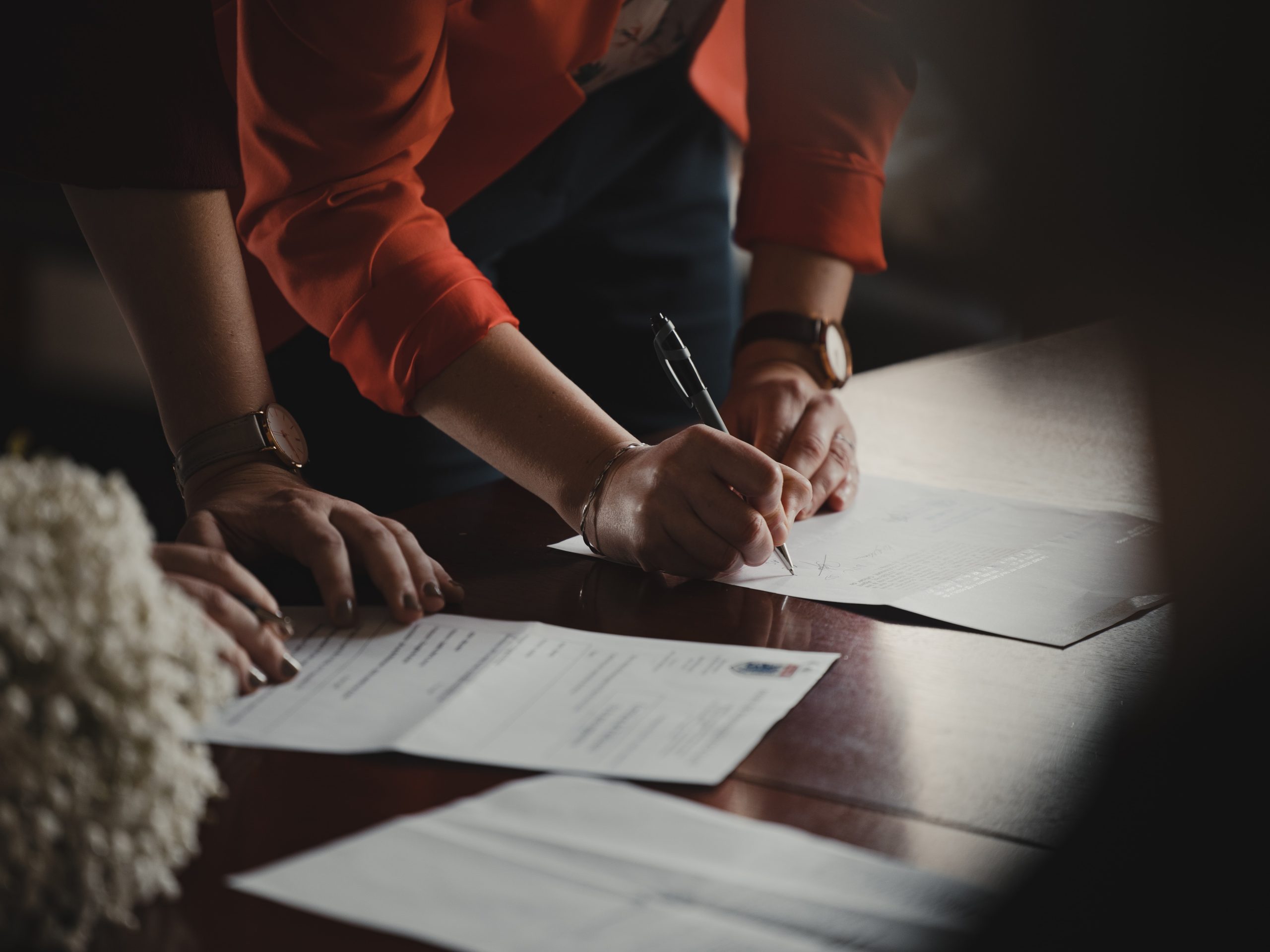 woman signing prenuptial agreement